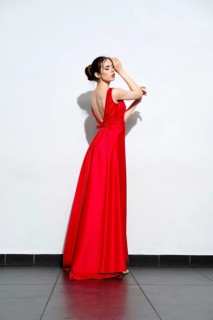Charming girl in waiving red silk dress with straps