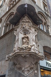 Madonna figure under a canopy on a corner house in the historic centre, Genoa, Italy, Europe