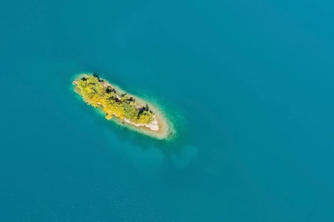 Bird's eye view of the chive island in the turquoise waters of Lake Walen in the canton of St.