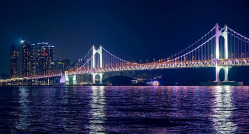 Gwangan Bridge and skyscrapers illuminated in the night. Busan, South Korea, Asia