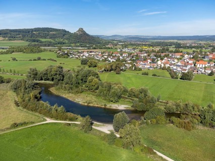 The Radolfzeller Aach with the village of Hausen an der Aach, on the horizon the Hegau volcano