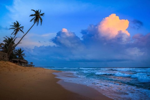 Romantic view of sunset on tropical beach. Hikkaduwa, Sri Lanka, Asia