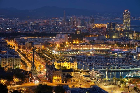 BARCELONA, SPAIN, APRIL 15, 2019: Aerial view of Barcelona city skyline with city traffic and port