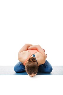 Woman doing Asthanga Vinyasa Yoga asana Yoga mudrasana (yoga mudra), psychic union pose isolated on
