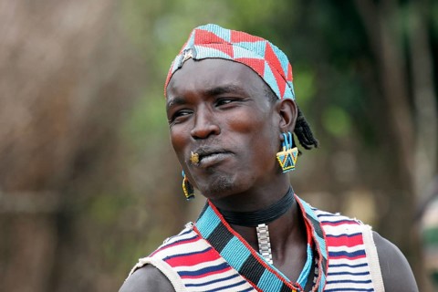 Man from the Bana tribe, Bena in traditional dress with colourful beads in Key Afar, Ethiopia,