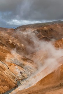 Steaming stream between colourful rhyolite mountains, Hveradalir geothermal area, Kerlingarfjöll,