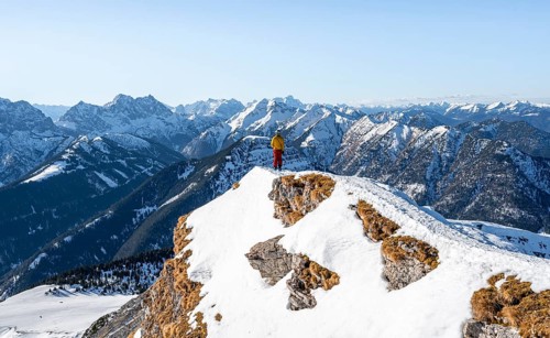 Ski tourers at the summit of Schafreuter, view of snowy mountain panorama, Karwendel, Tyrol,