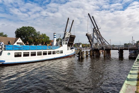 Excursion boat passing through open drawbridge, double balance beam bridge, Wiecker wooden bascule