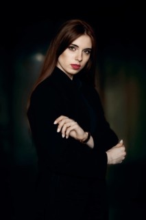 Low key portrait of beautiful girl with natural make up and red lips