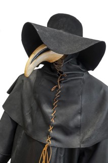 Black wide-brimmed hat, overcoat and beaked mask for plague doctor to treat victims of bubonic