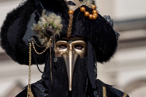 Beak mask, plague mask, mask wearer at the Venetian fair on the historic market square,
