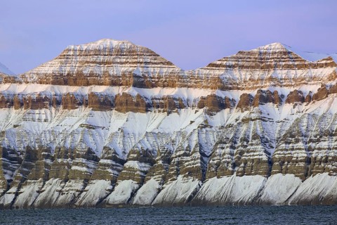 Snow covered Carboniferous mountain slope showing strata in autumn, Billefjord, Billefjorden,