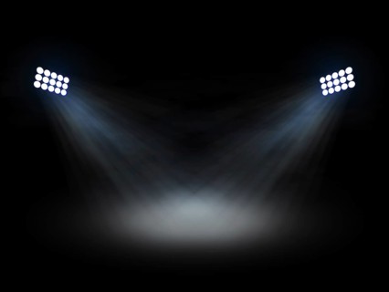 Stadium theater floolights spotlights with light beams on black background