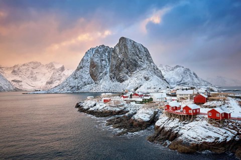 Famous tourist attraction Hamnoy fishing village on Lofoten Islands, Norway with red rorbu houses.