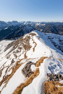 Ski tourers at the summit of Schafreuter, view of snow-covered mountain panorama, Karwendel, Tyrol,