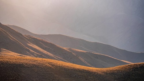 Mountain landscape detail in the evening light, Hills overgrown with yellow grass, Toktogul