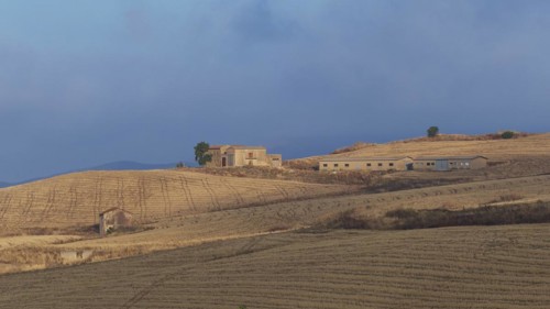Dry hilly landscape, fields, farmstead, building, blue cloudy sky, Madonie National Park, autumn,