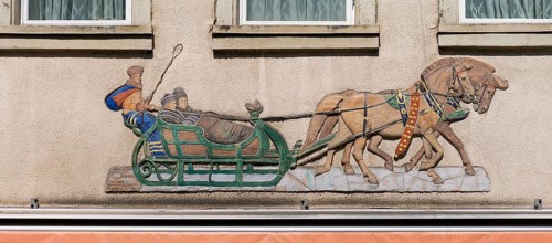 Historical relief on a house facade, people in a horse-drawn sleigh, Emmendingen,