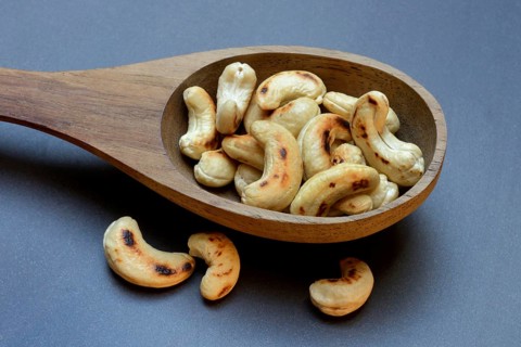 Cashew, roasted cashews in wooden ladle