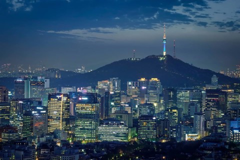 Seoul downtown cityscape illuminated with lights and Namsan Seoul Tower in the evening view from