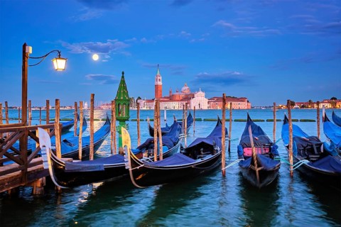 Romantic vacation Venice travel background, gondolas at Saint Mark (San Marco) square and Basilica