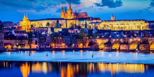 Panorama of Prague Castle and St. Vitus cathedral in twilight with dramatic sky. Prague, Czech