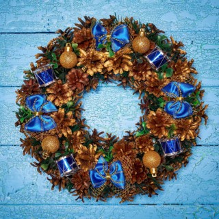 Christmas wreath on blue painted wooden background
