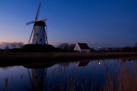 The traditional windmill Schellemolen at sunset along the Damme Canal, Damme, West Flanders,