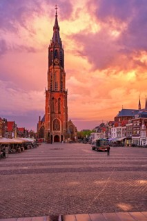 Nieuwe Kerk New Church protestant church on Delft Market Square Markt with dramatic sky on sunset.