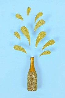 Golden splashing Champagne bottle on blue background