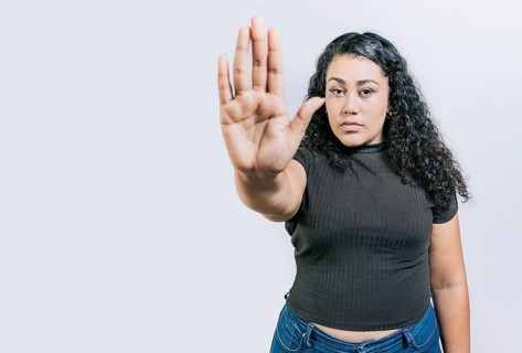 Serious woman rejecting with the palm of hand isolated. People gesturing stop isolated. Latin woman