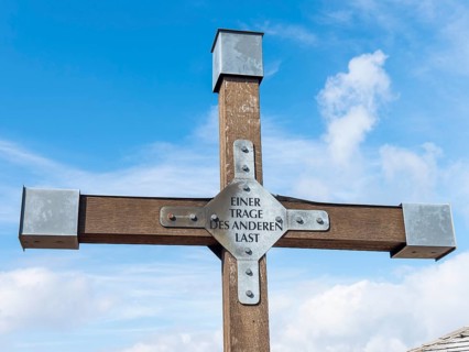 Christian cross with inscription, One bears the other's burden, Hochwald summit, Zittau Mountains,