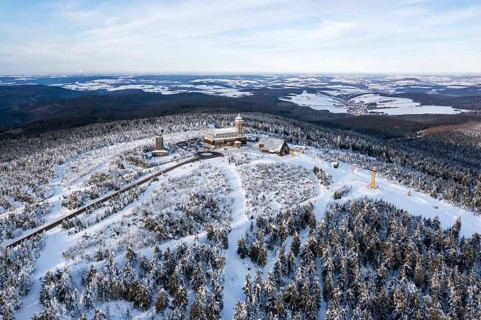 Fichtelberg highest mountain in the Ore Mountains in winter aerial view in Oberwiesenthal, Germany,