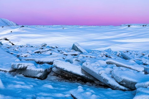 Icefall at the river Skialfandafljot at blue hour, near the waterfall Godafoss, snow-covered