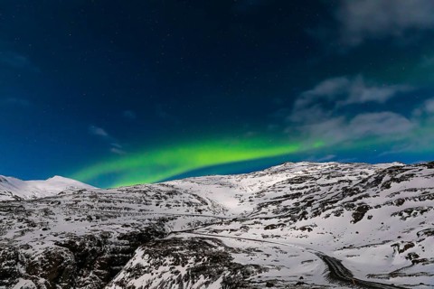 Northern Lights, Aurora Borealis, over snow-covered landscape at Skalafellsjökull, Sudurland,