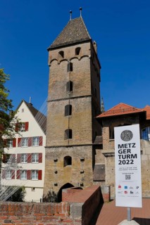 Metzgerturm with an installation by Johannes Pfeiffer, poster, information board, logos,