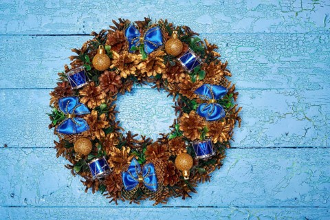 Christmas wreath on blue painted wooden background