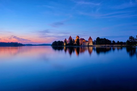 Trakai Island Castle in lake Galve illuminated in night, Lithuania, Europe