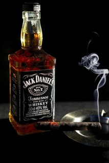 Minsk, Belarus, January 25, 2016: Bottle of Jack Daniel's near ashtray with smoking cigar, Europe