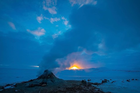 Mud pot with steam source at sunrise, Hverir solfataras field, fumaroles, snow-covered geothermal