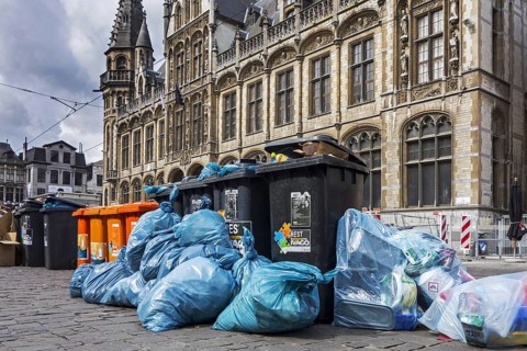 Rubbish bags and garbage containers with piled up household refuse due to strike by the waste