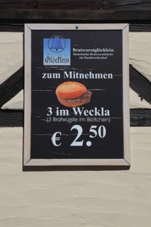 In the old town of Nuremberg, advertising sign of the restaurant, Bratwurstglöcklein, three in the