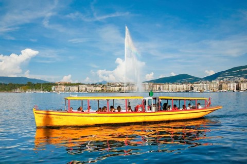 The Jet d'eau, and the Mouettes genevoises in sunshine and blue sky, landmark in the Geneva harbour