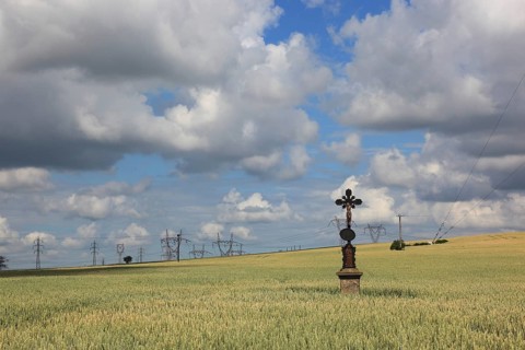 Field cross in a wheat field, in the background power lines, near Dukovany, Czech Republic, Grain