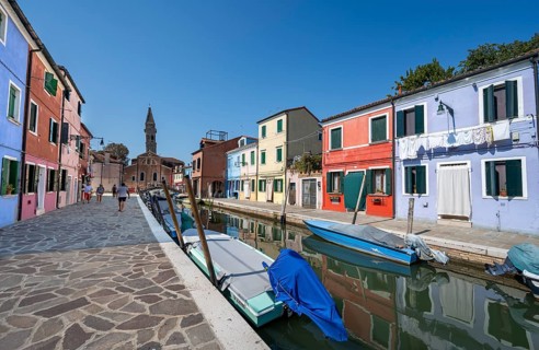 Colourful houses on the canal with reflection, canal with boats and colourful house facades, in the