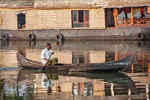 KERALA, INDIA, MAY 5, 2010: Unidentified indian man in small boat in backwaters. Kerala backwaters