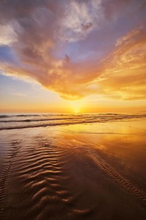 Atlantic ocean sunset with surging waves at Fonte da Telha beach, Costa da Caparica, Portugal,