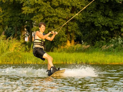 Young man riding wakeboard in lake, Leisure and water sports, Germany, Europe