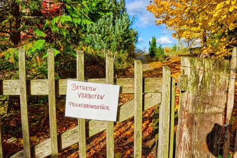 No Trespassing Private Property, sign on a garden gate made of wooden slats