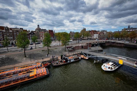 AMSTERDAM, NETHERLANDS, MAY 9, 2017: Aerial view of Amsterdam canal with tourist boats near
